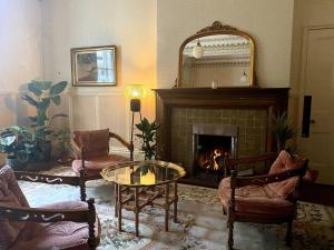 a living room with a fireplace and a mirror at Mossley Hill Retreat in Liverpool