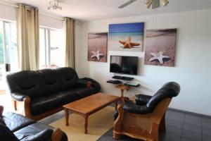 a living room with a couch and a tv at Laguna La Crete 166 in Margate