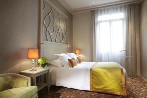 a bedroom with a large bed and a window at Splendid Etoile in Paris