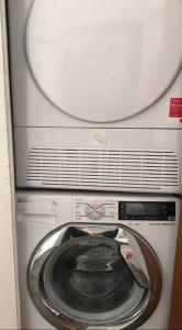 a washer and dryer sitting in a room at Designer Central Apartment with Parking & Terrace in Berlin
