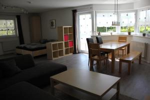 uma sala de estar com uma mesa e um sofá em Ferienwohnung Bucher em Tettnang