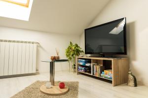 a living room with a large flat screen tv at Sunny day apartments in Sveta Nedjelja