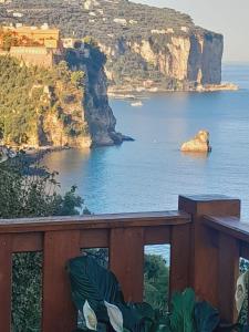 a view of a body of water with a rock in the ocean at La Palombara B&B in Vico Equense