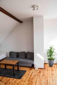 a living room with a couch and a table at Schöne Dachgeschosswohnung nahe Köln in Cologne