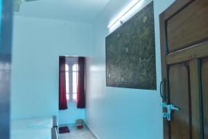 a hallway with a door and a window at Suryas Rooms in Varkala