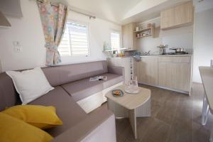 a living room with a couch and a table at Camping Bellsol Pets in Pineda de Mar