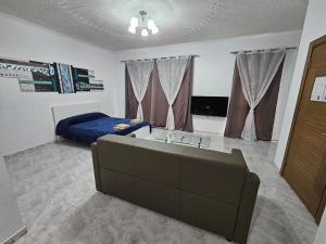 a bedroom with a couch and a bed in it at Sea-View Studio Apartment - Sleeps 2 in Marsaskala