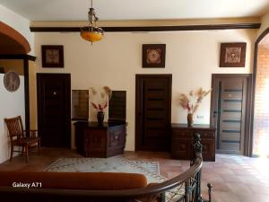 a living room with two doors and a couch at Hotel Jan & in the very center in Yerevan