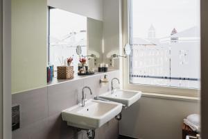 two sinks in a bathroom with a large window at The Circus Apartments in Berlin +112 photos