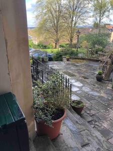 a patio with potted plants on the side of a building at Beautiful 2 bedroom garden flat in great location in Bristol