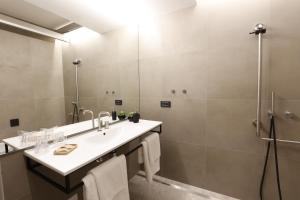 a bathroom with a sink and a shower at FLORAMARE HEALTH RESORT in Izola