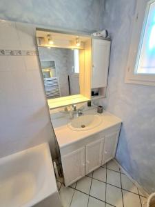 a white bathroom with a sink and a mirror at Maison au calme . 5ième arr . Ouest Lyonnais in Lyon