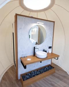a bathroom with a sink and a mirror at Glamping Balú in Monesterio