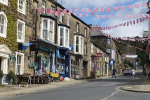 a street with a bunch of flags and buildings at Ashfield House in Pateley Bridge