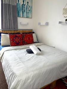 a bed with two towels on it in a room at Comfortable and convenient 1-Bed Apart in Romford in Romford