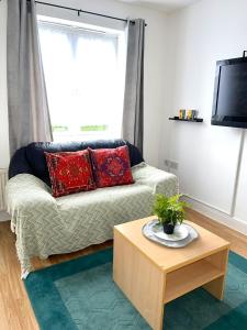 a living room with a couch and a coffee table at Comfortable and convenient 1-Bed Apart in Romford in Romford