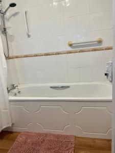 a white bath tub in a bathroom at The Cottage in Abergavenny +15 photos