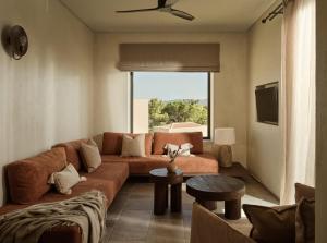 a living room with a couch and a tv at Pierros Verde in Lithakia