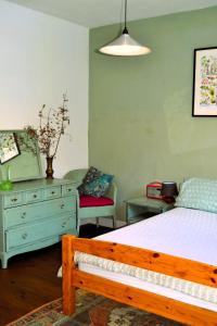 a bedroom with a bed and a dresser at Gite Esmeralda in Biert