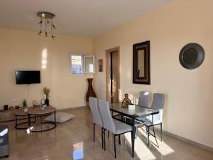 a living room with a dining room table and chairs at Aegean View House in Agios Ioannis