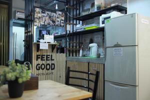 a kitchen with a table and a refrigerator at Feel good pinklao in Bangkok