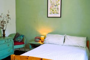 a bedroom with a bed and a table with a clock at Gite Esmeralda in Biert +27 photos