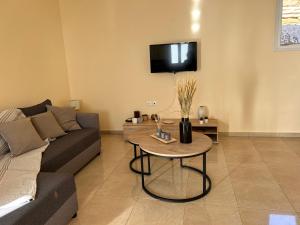 a living room with a couch and a table at Aegean View House in Agios Ioannis