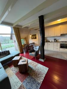 a living room with a couch and a table at De Veurdeale in Havelte