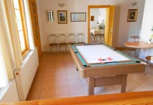 a pool table in a room with chairs at Penzion Hron in Brezno