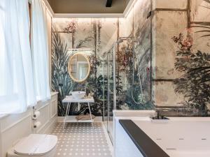 a bathroom with a shower and a toilet and a sink at Hotel Villa Cariola in Caprino Veronese