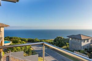 a view of the ocean from the balcony of a house at Luxury Views + Excellence - Pezula no Loadshedding in Knysna