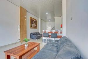 a living room with a couch and a table at Tera Guest House in Kedaton