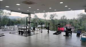 a gym with several treadmills and a large window at 365 Homestay in Kaki Bukit