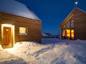 a house in the snow at night at Feriendorf Wasserkuppe 