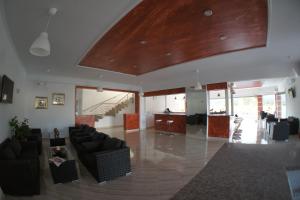 a living room with couches and a wooden ceiling at Hotel Alexandros in Ammoudia