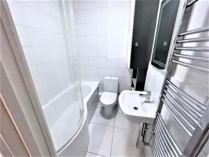 a white bathroom with a toilet and a sink at Remarkable 1-Bed Apartment in High Wycombe in High Wycombe