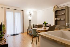a kitchen and living room with a table and a couch at Delalauret Apartment - Vannes Centre in Vannes