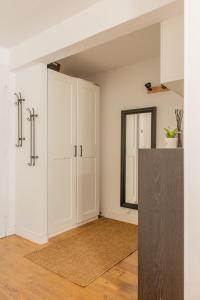 an empty room with white cabinets and a mirror at Delalauret Apartment - Vannes Centre in Vannes
