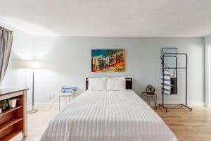 a bedroom with a large white bed in a room at Capri 108 in Marco Island