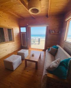 a living room with a couch and a table at Punta de Choros Lodge in Punta de Choros