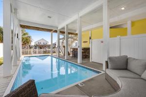 a swimming pool in the middle of a house at Bird's Nest in Holden Beach