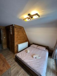 a bedroom with a bed with two towels on it at Cabana Cerbului in Cluj-Napoca
