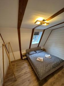 a small bedroom with a bed in a attic at Cabana Cerbului in Cluj-Napoca