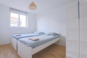 Postel nebo postele na pokoji v ubytování Appartement Familial - Avec Parking Privé Gratuit
