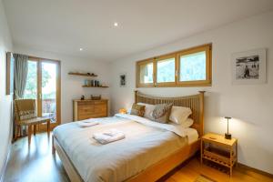 a bedroom with a large bed with two towels on it at Chalet Aquila 5 in Wengen