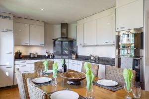 a kitchen with a wooden table with chairs and a dining room at Chalet Aquila 5 in Wengen