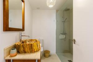 a bathroom with a wooden sink and a shower at A&N Piramides 3 in Vélez-Málaga