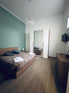 a bedroom with a large bed and a mirror at Home Sweet Home da Viky in Bari