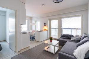 a living room with a couch and a table at Lumiapartment1 in Rovaniemi