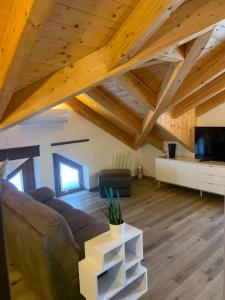a living room with a couch and a tv at La Mansarda nel Borgo in Borgo Venusio